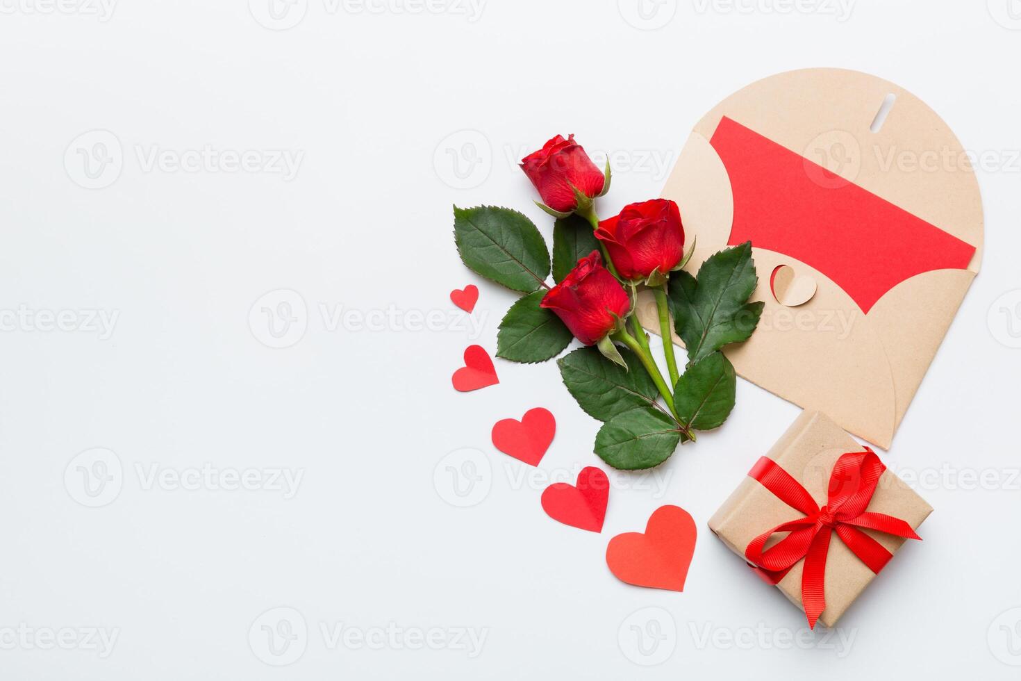 Valentine day composition with envelope rose flower and red heart on table. Top view, flat lay, copy space Holiday concept photo