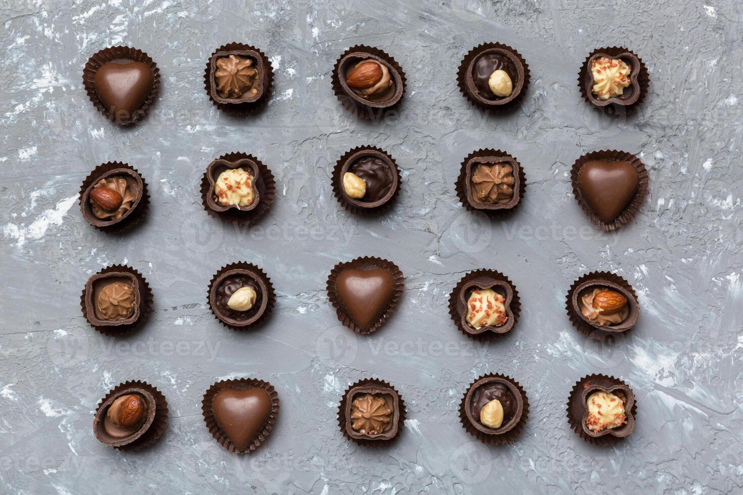 Different kinds of chocolates on colored table close. Top View and Flat Lay photo