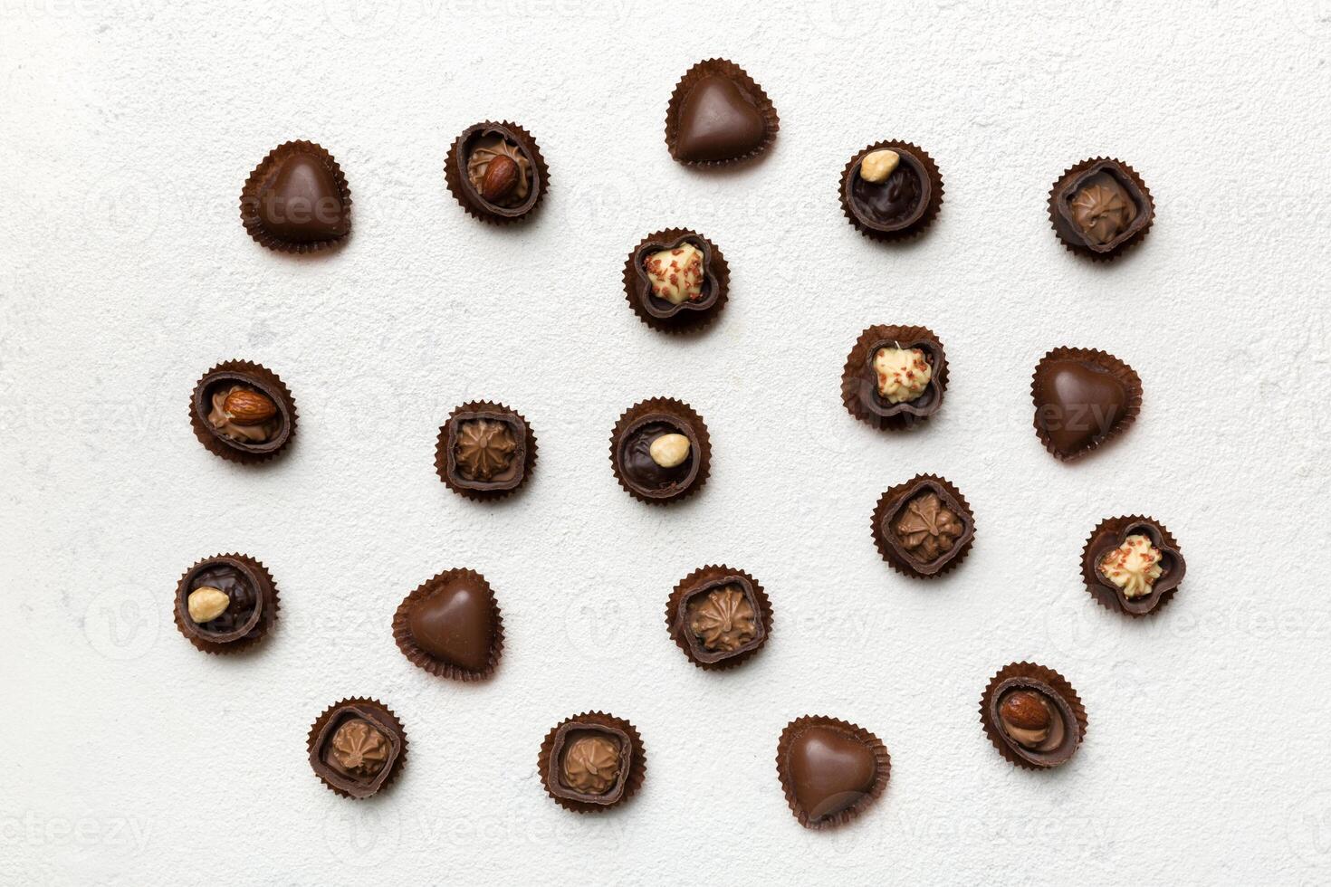 Different kinds of chocolates on table close-up. Top View and Flat Lay photo