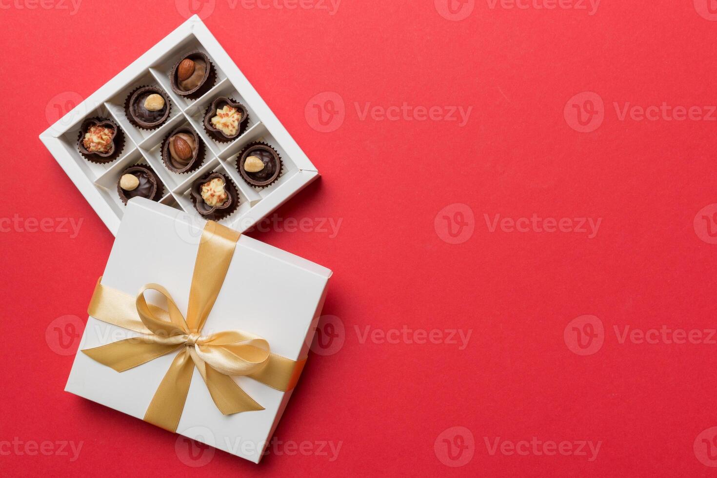 White box chocolates candies and golden tape. top view with copy space photo