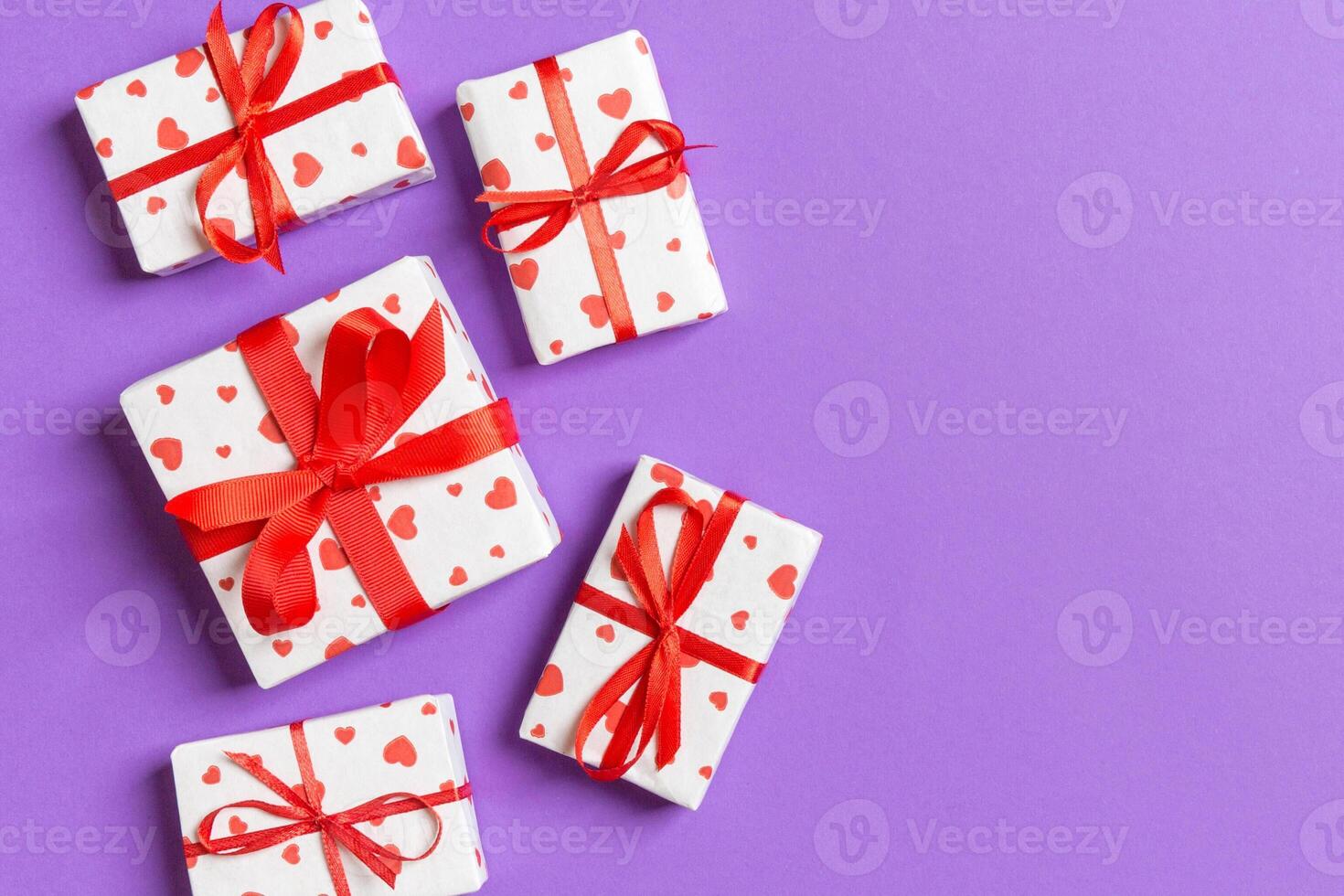 Top view colorful valentine background made gift boxes with red hearts. Valentine's Day concept with copy space photo