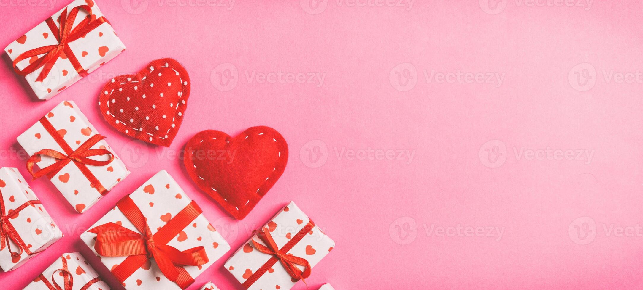 Top view of gift boxes red textile hearts on colorful background. St Valentine's day concept with copy space photo