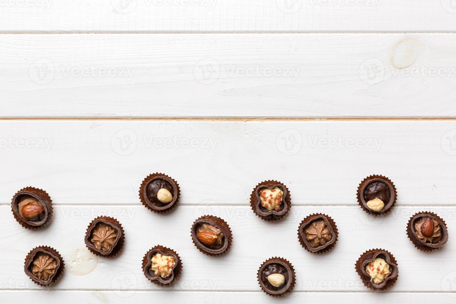 Different kinds of chocolates colored table close-up. Top View and Flat Lay photo
