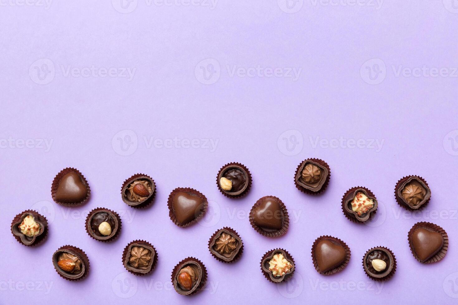 Different kinds chocolates on colored table close-up. Top View and Flat Lay with copy space photo