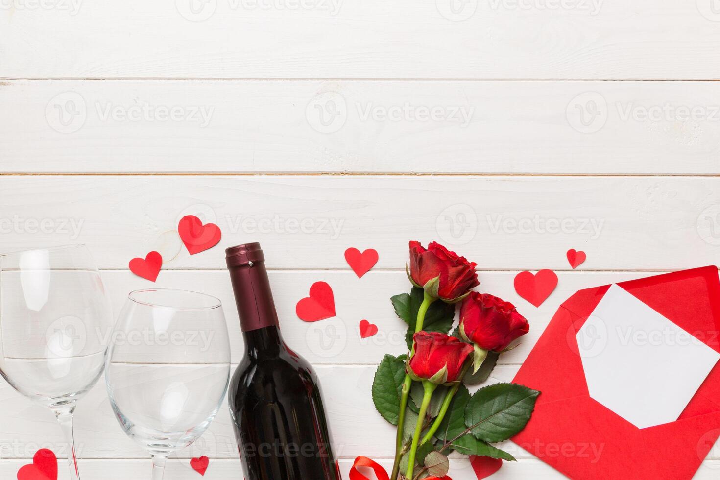 Valentine day composition with red wine, rose flower and gift box on table. Top view, flat lay. Holiday concept photo