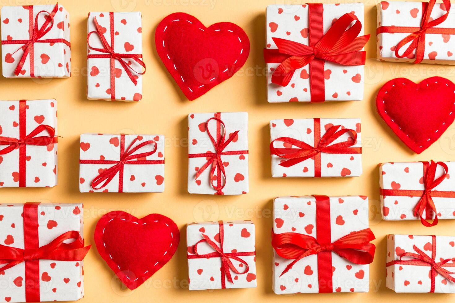 Top view white gift boxes and red textile hearts on colorful background. Valentine's Day concept photo