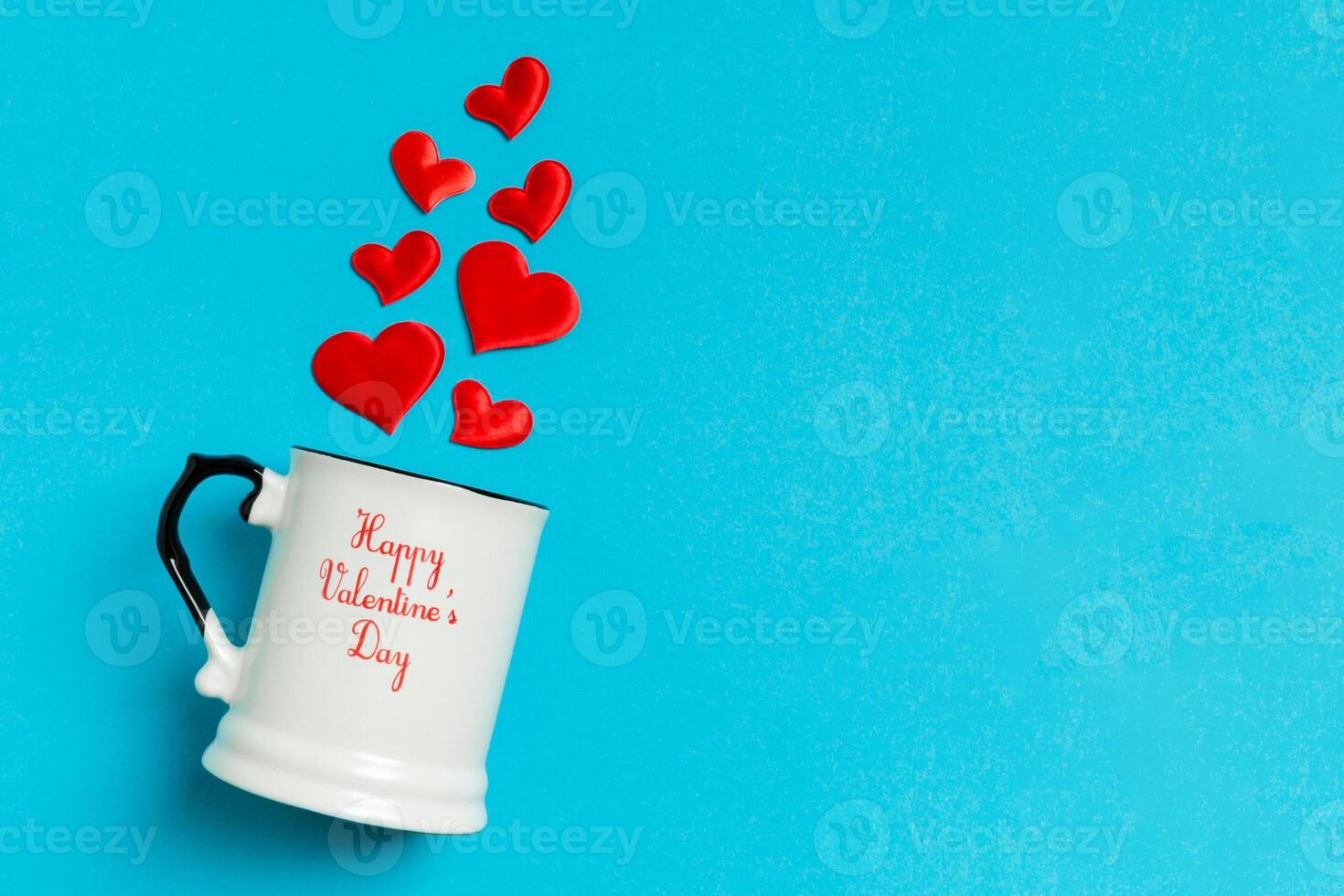 Top view composition of red hearts falling out from cup on colorful background with copy space. Romantic relationship concept. St Valentaine's Day photo
