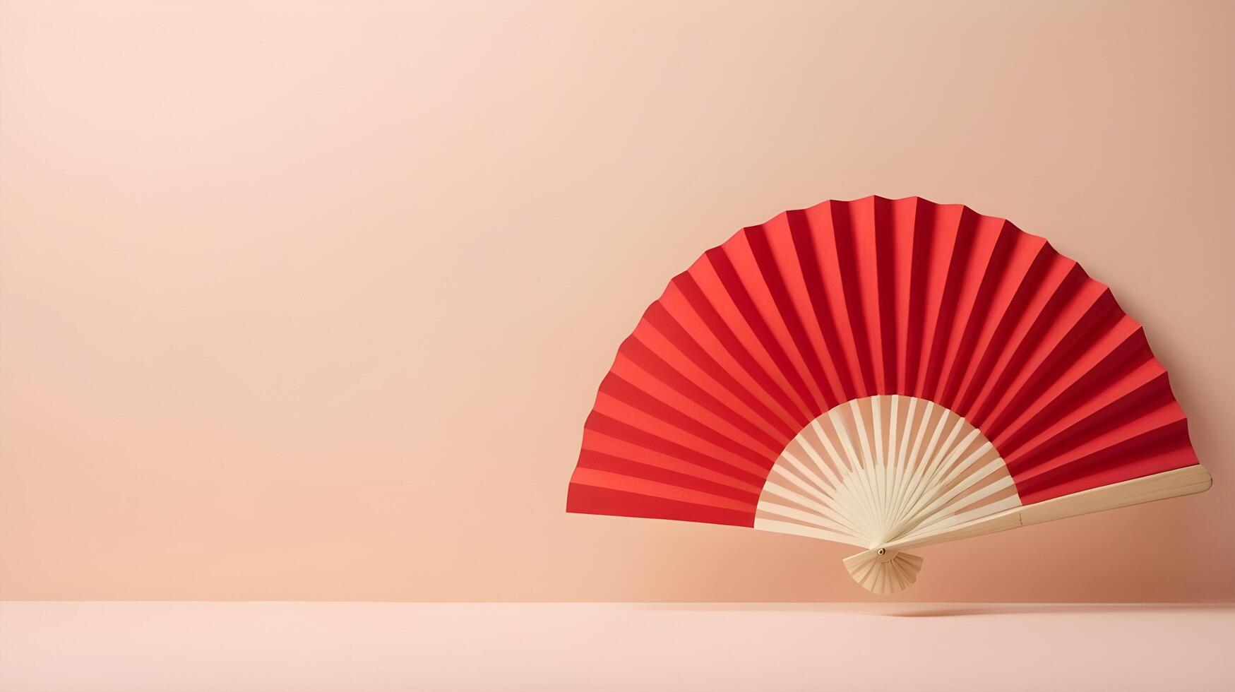 A minimalist red paper fan placed against a soft cream backdrop, with plenty of empty space for text or a logo. photo