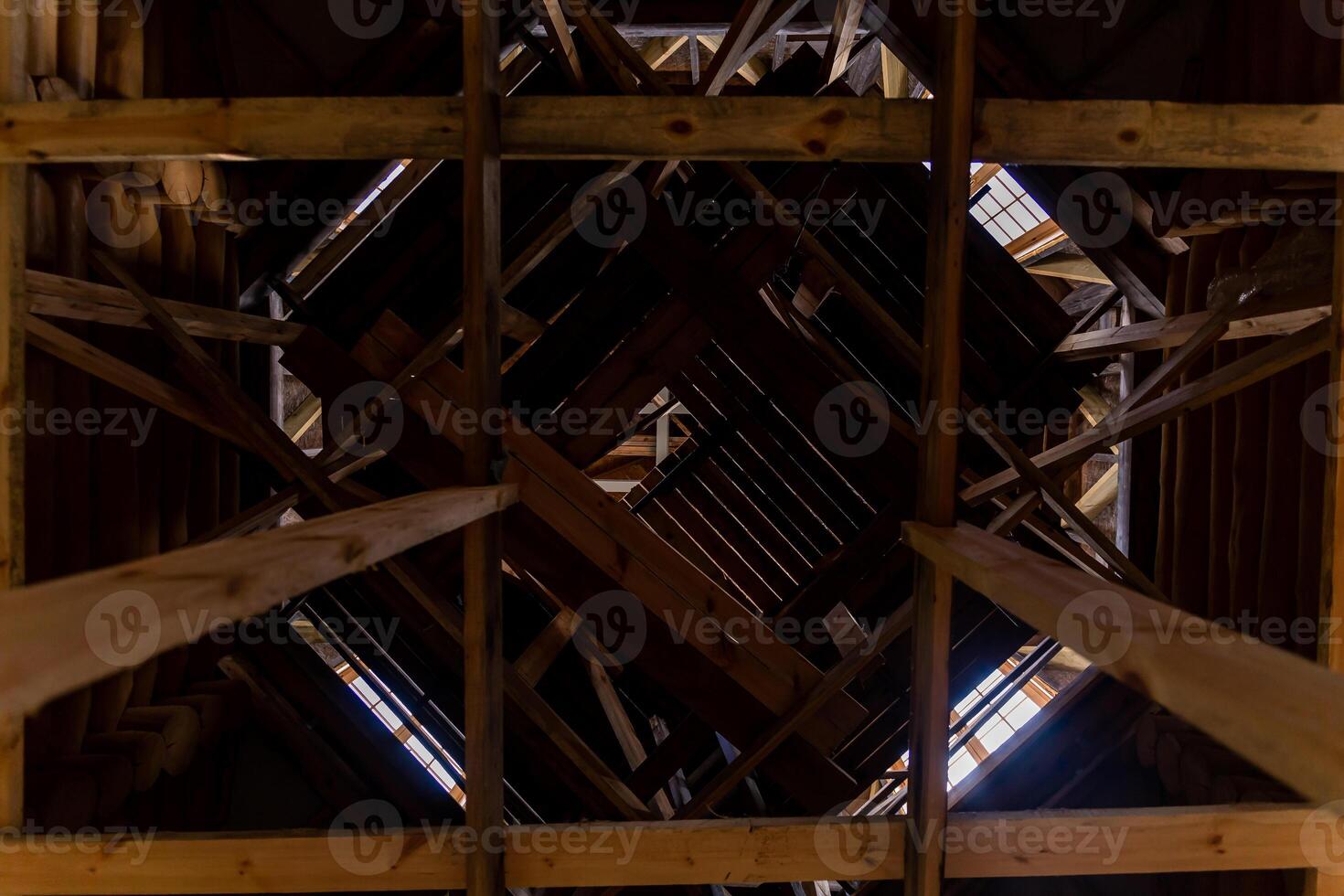 Intricate Wooden Roof Framework with Central Square Opening photo