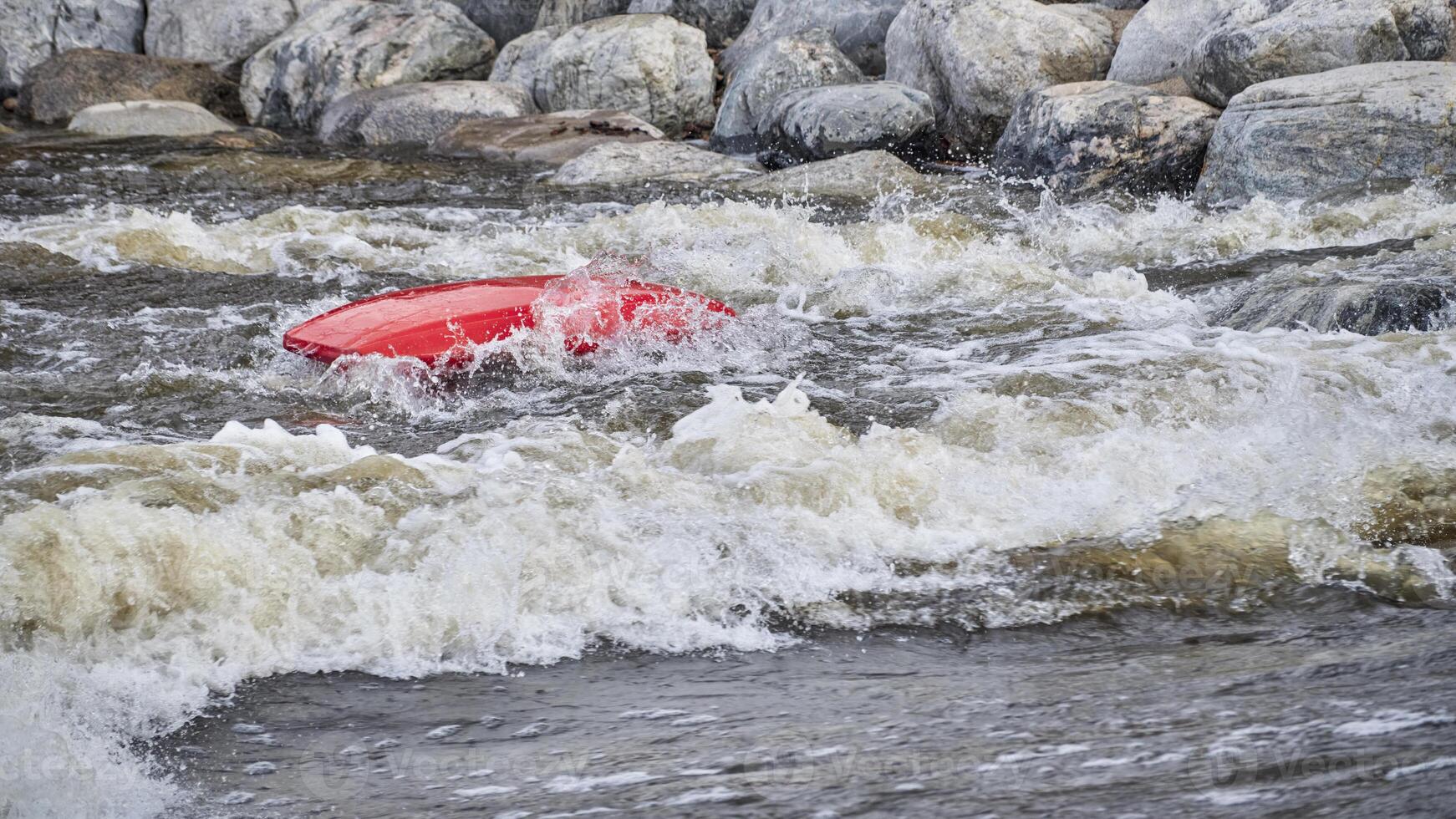 kayaker surfing wave in Poudre River Whitewater Park in Fort Collins, CO photo