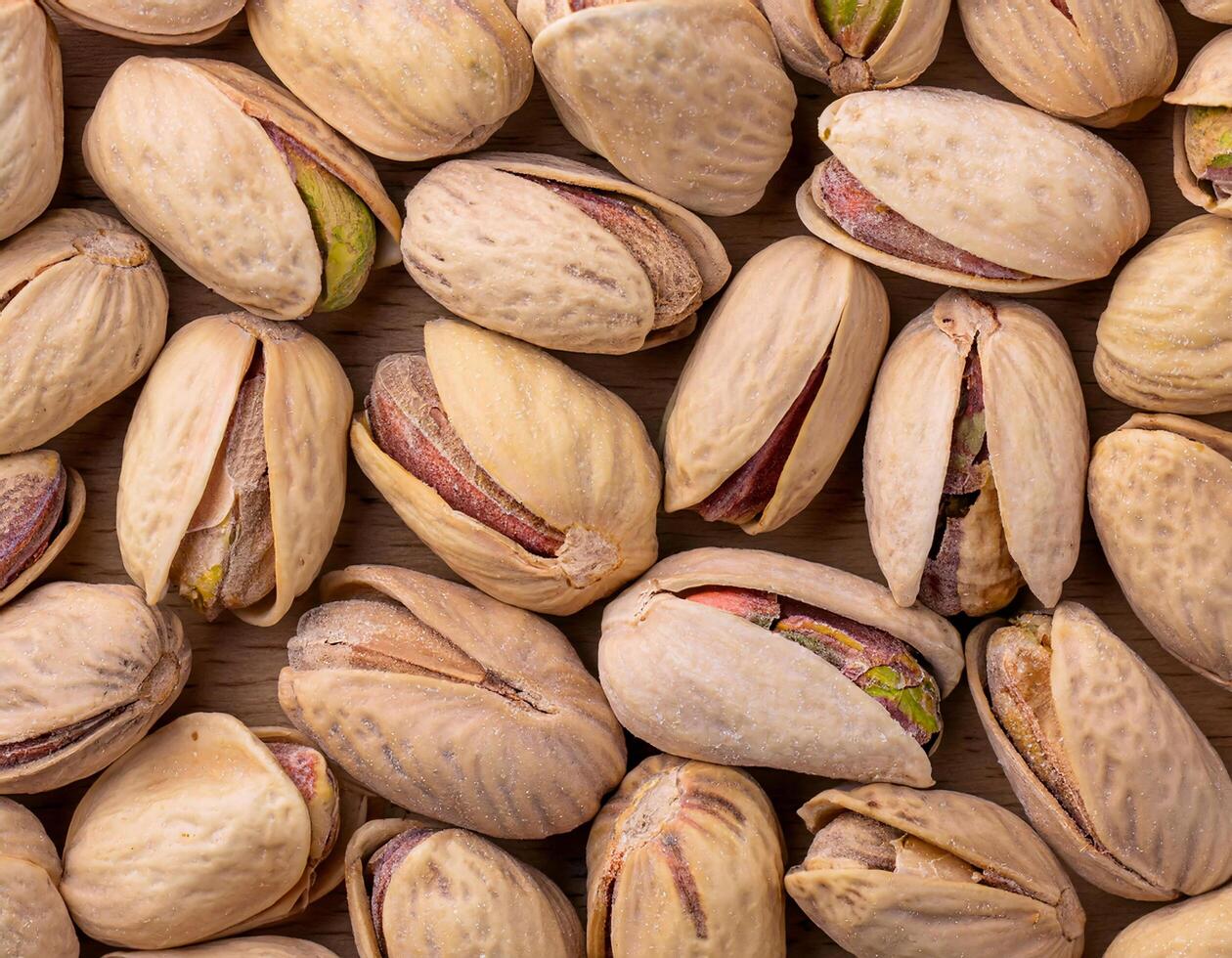 pistachio nuts arranged neatly, showcasing their textured shells and vibrant green kernels. photo