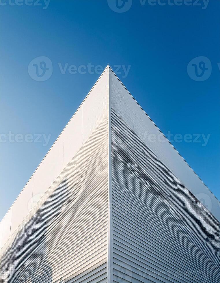 Low Angle View of a Modern White Building Against a Clear Blue Sky photo