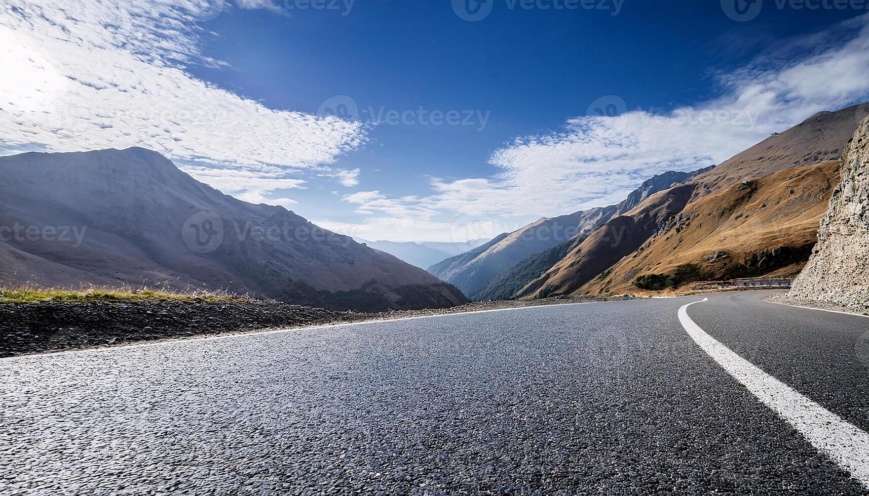 Beautiful Mountain Road Surrounded by Majestic Peaks and Sky photo