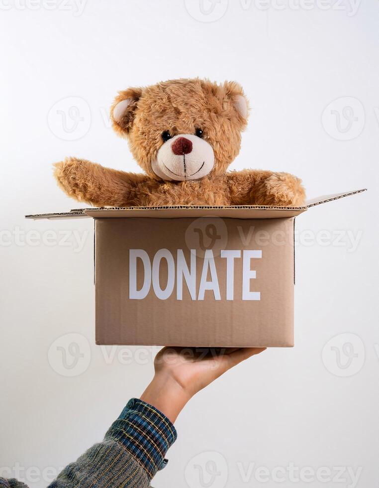 Charity in Action. Open Box Marked 'Donate' Filled with a Doll photo