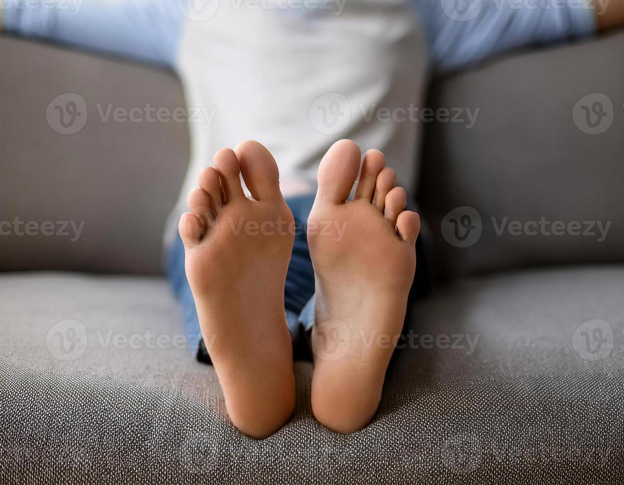 Unwinding at Home. Man Lying on Grey Couch in Living Room photo