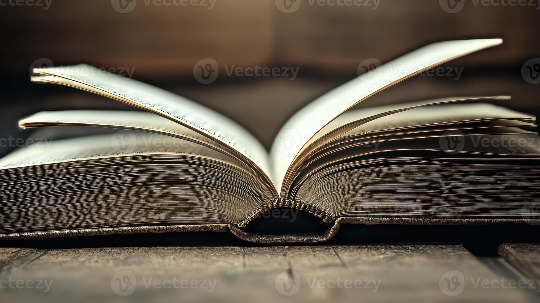 An open book on a wooden table photo
