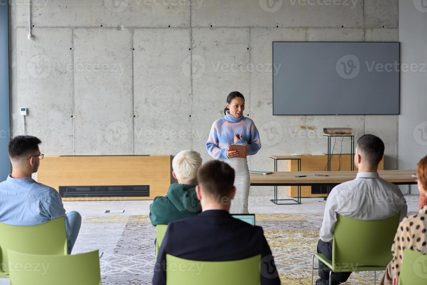 A businesswoman leader guiding a meeting with her colleagues, discussing business challenges, marketing strategies, and new plans for growth and success photo