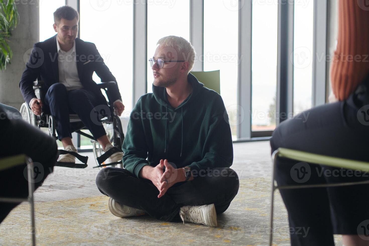 Corporate business team meeting with a manager or coach. Group of happy diverse, multiracial people sitting in a circle photo