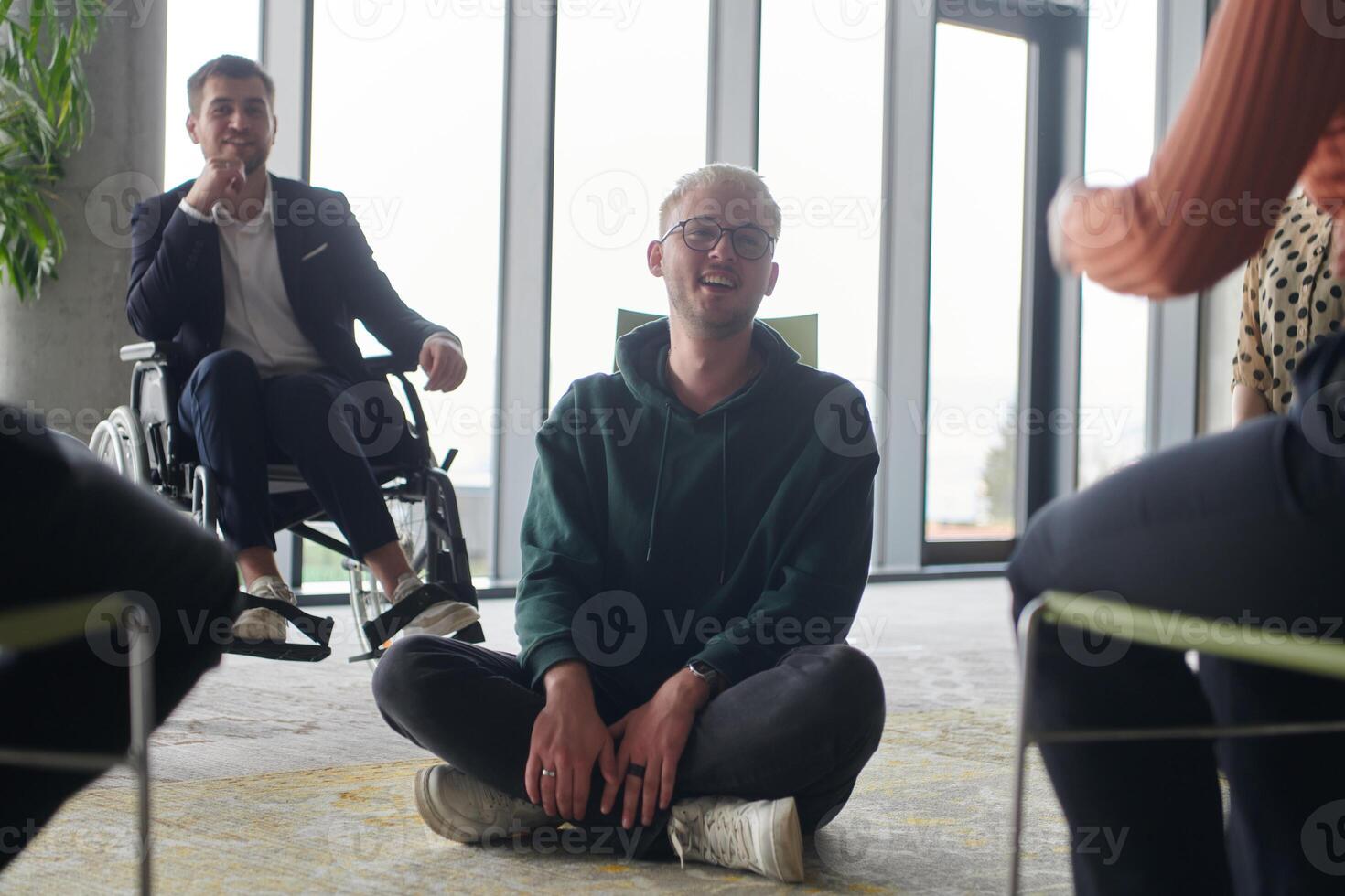 Corporate business team meeting with a manager or coach. Group of happy diverse, multiracial people sitting in a circle photo