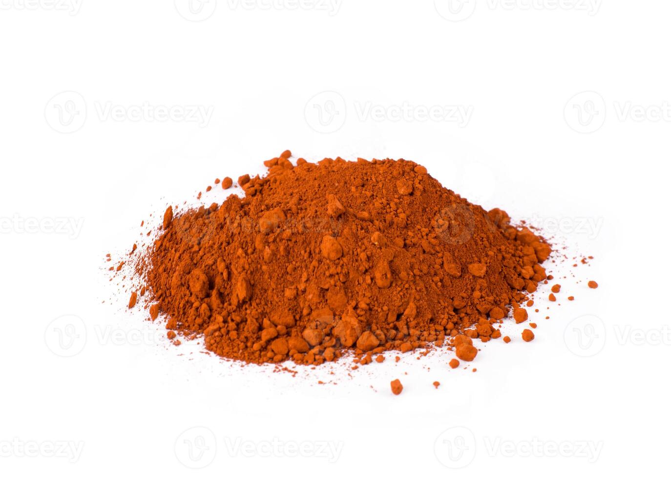 English Red. Bright Red Spice Heaped on a Clean Surface With a Scoop Showing Texture and Color Variation photo