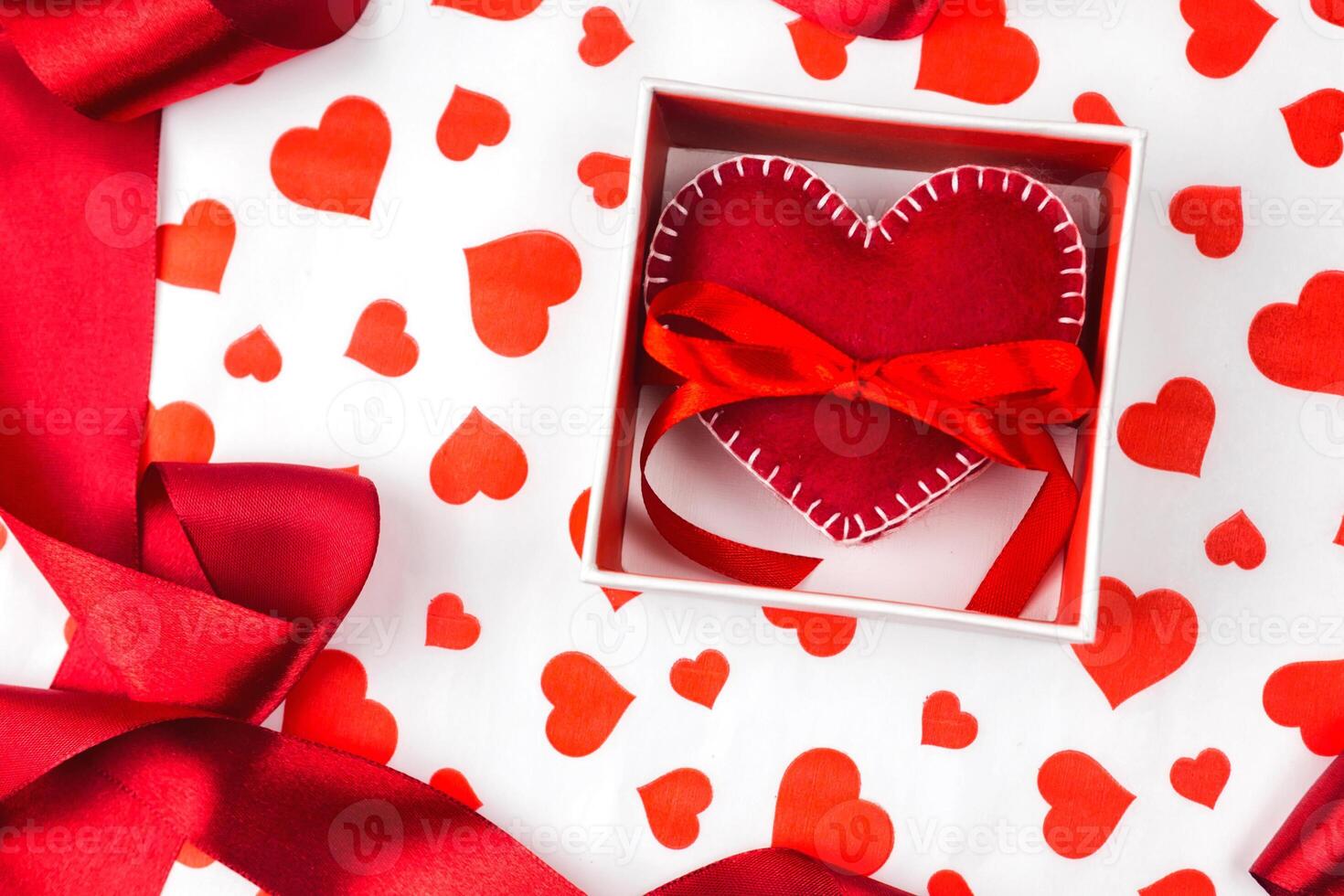 background to Valentine's Day or romantic event. heart in the gift box against the background of the hearts. photo