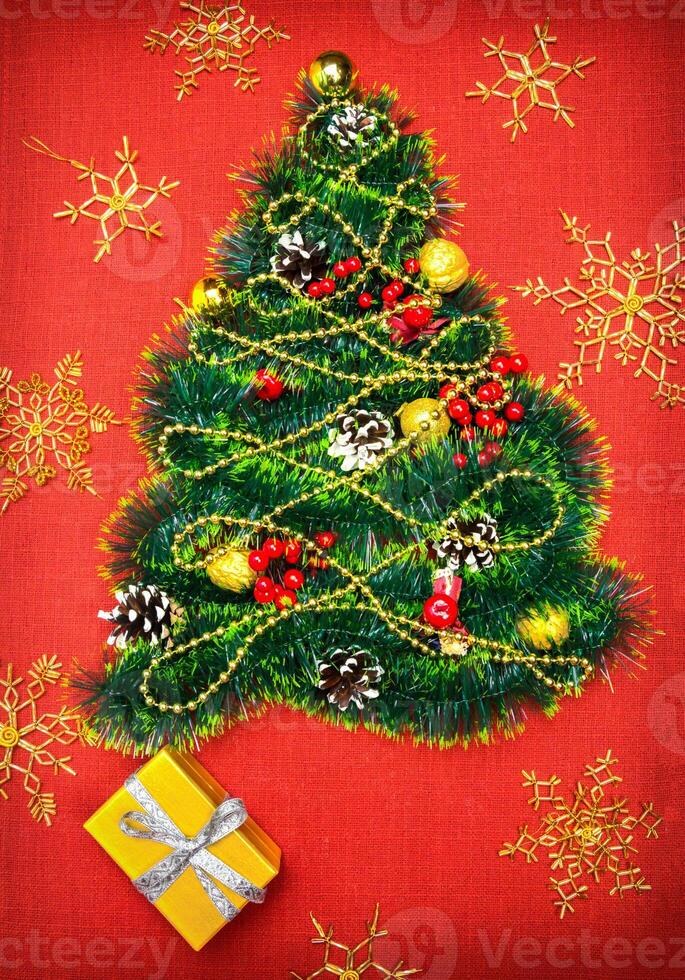 a small Christmas tree of tinsel, nuts, ribbons and ornaments. Gift for a Christmas tree, a vintage watch. 2026 photo