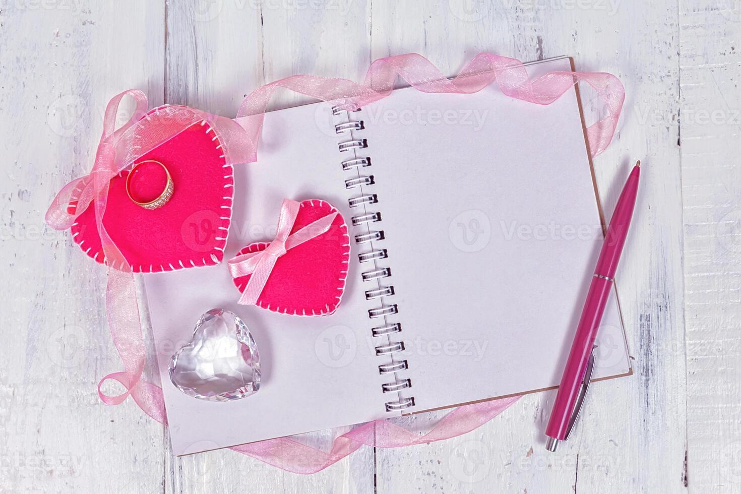 Valentines day toy hearts and notepad for your text. Top view on wooden table. photo
