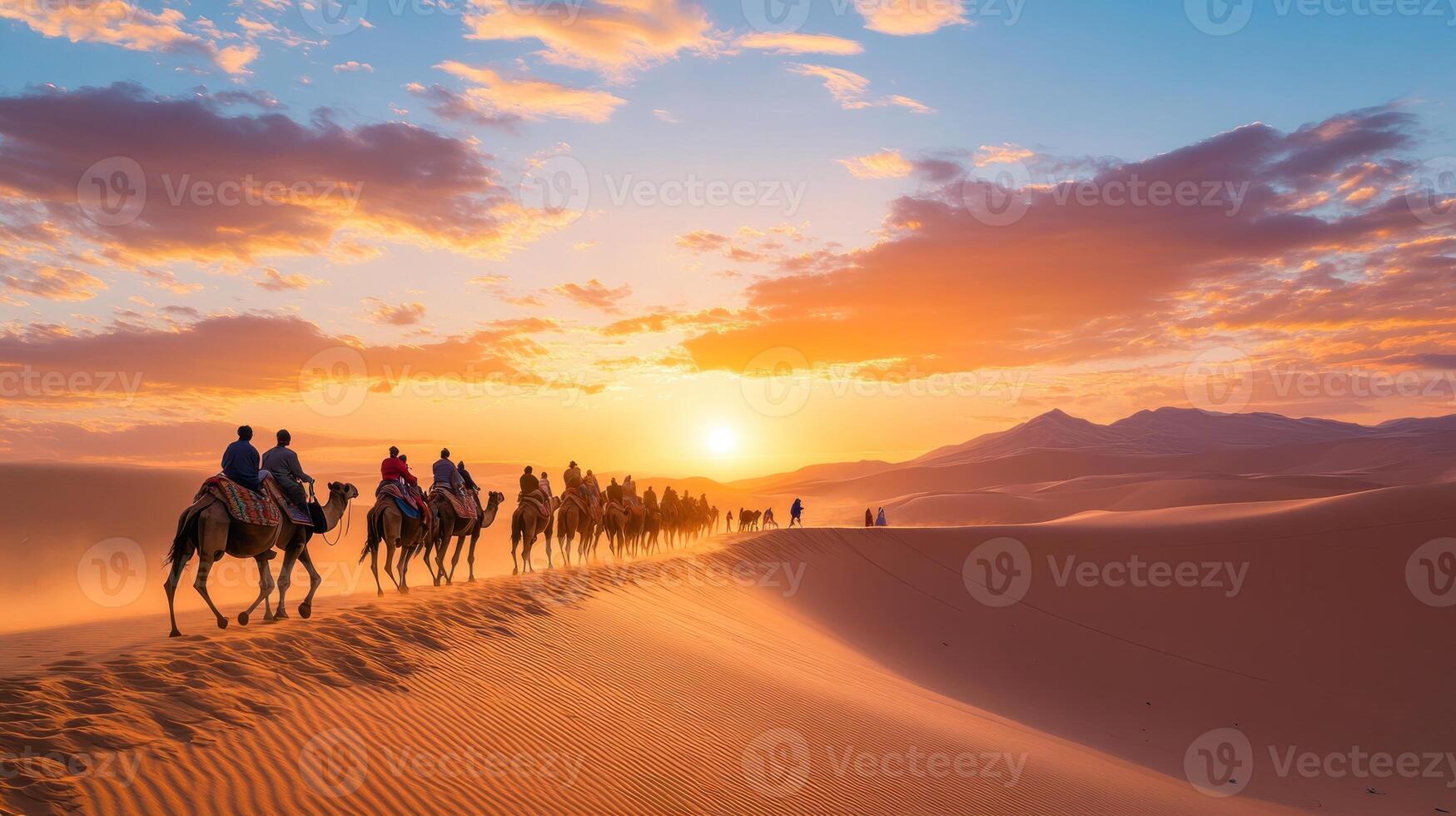 Camel Caravan Crossing a Desert Under a Sunset Sky photo