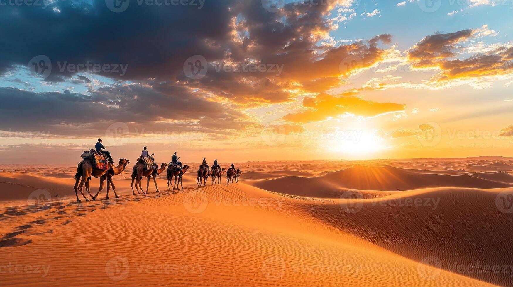 Camel Caravan Crossing Desert Dunes at Sunset photo