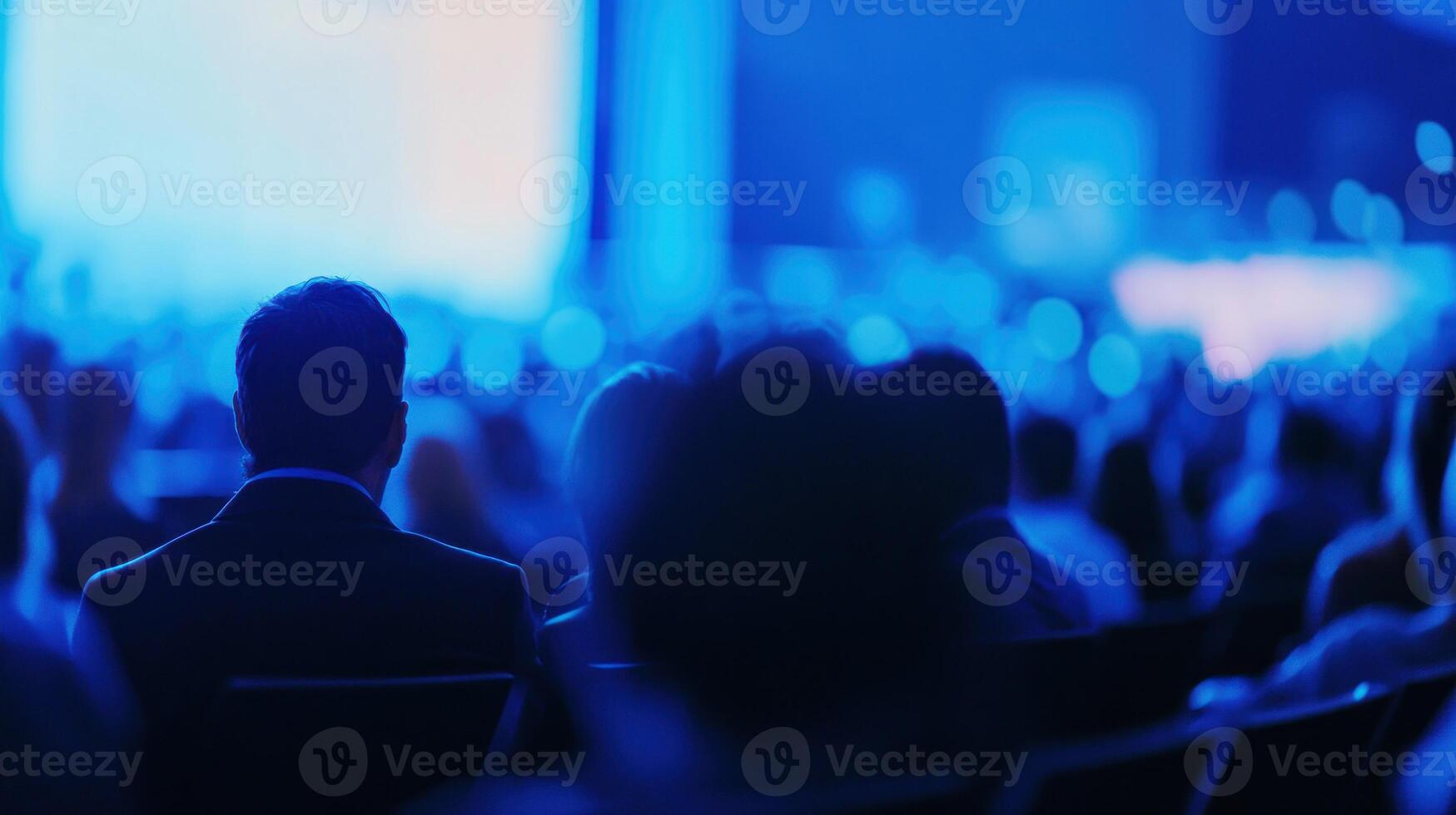 Silhouetted Audience Member at a Blue-Lit Event photo