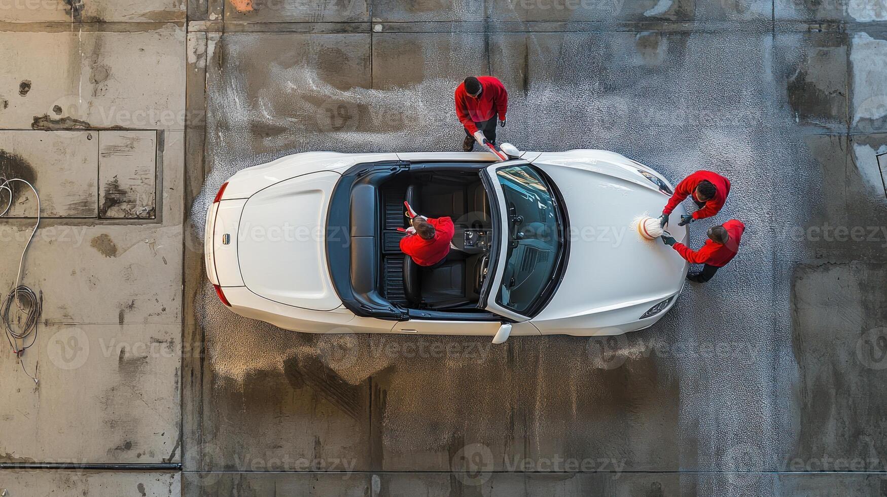Aerial View of White Convertible Car Being Washed by Workers photo