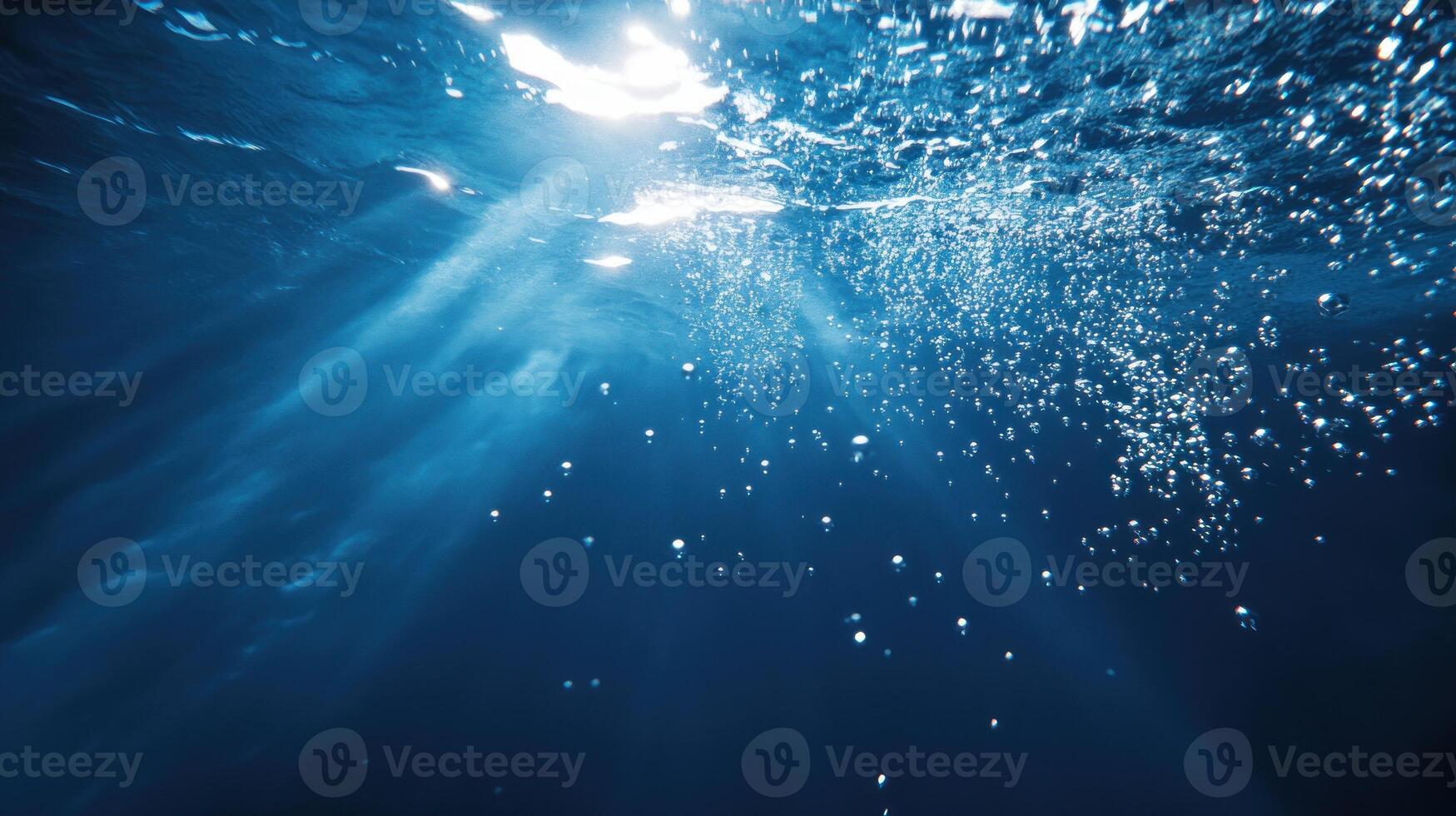 Sunlight Beams and Bubbles Under the Ocean Surface photo