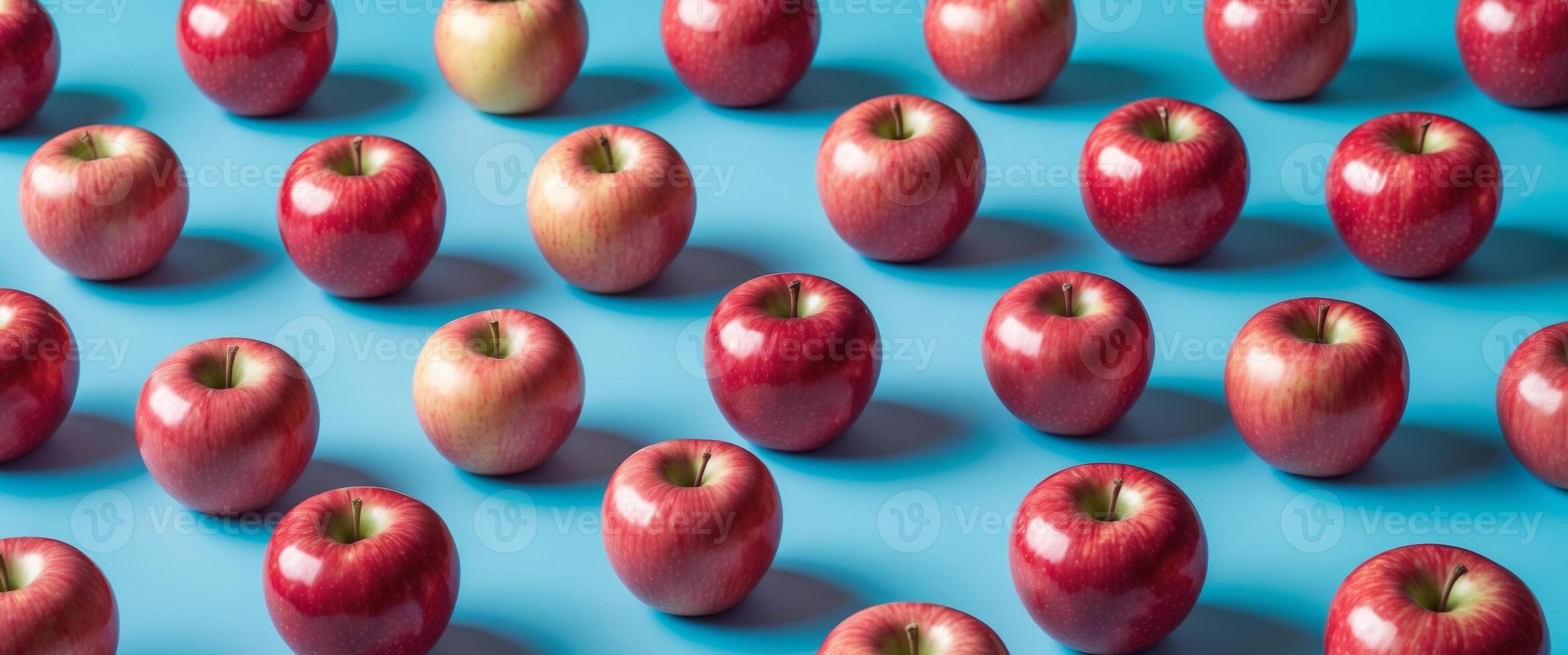 Fresh red apples arranged on a vibrant blue background symbolizing innovative agricultural practices and premium quality produce. photo