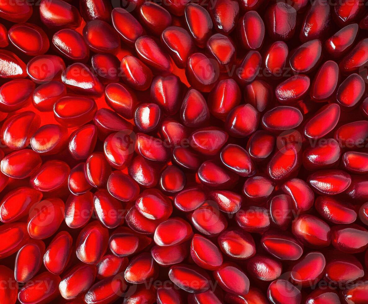 Vibrant red pomegranate seeds arranged closely, showcasing their glossy texture and deep color under bright light photo