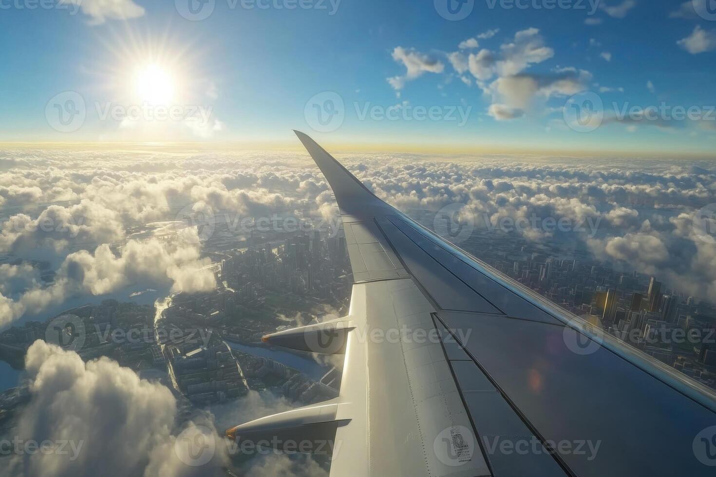 Captivating view from airplane wing soaring above clouds at sunset over city landscape photo