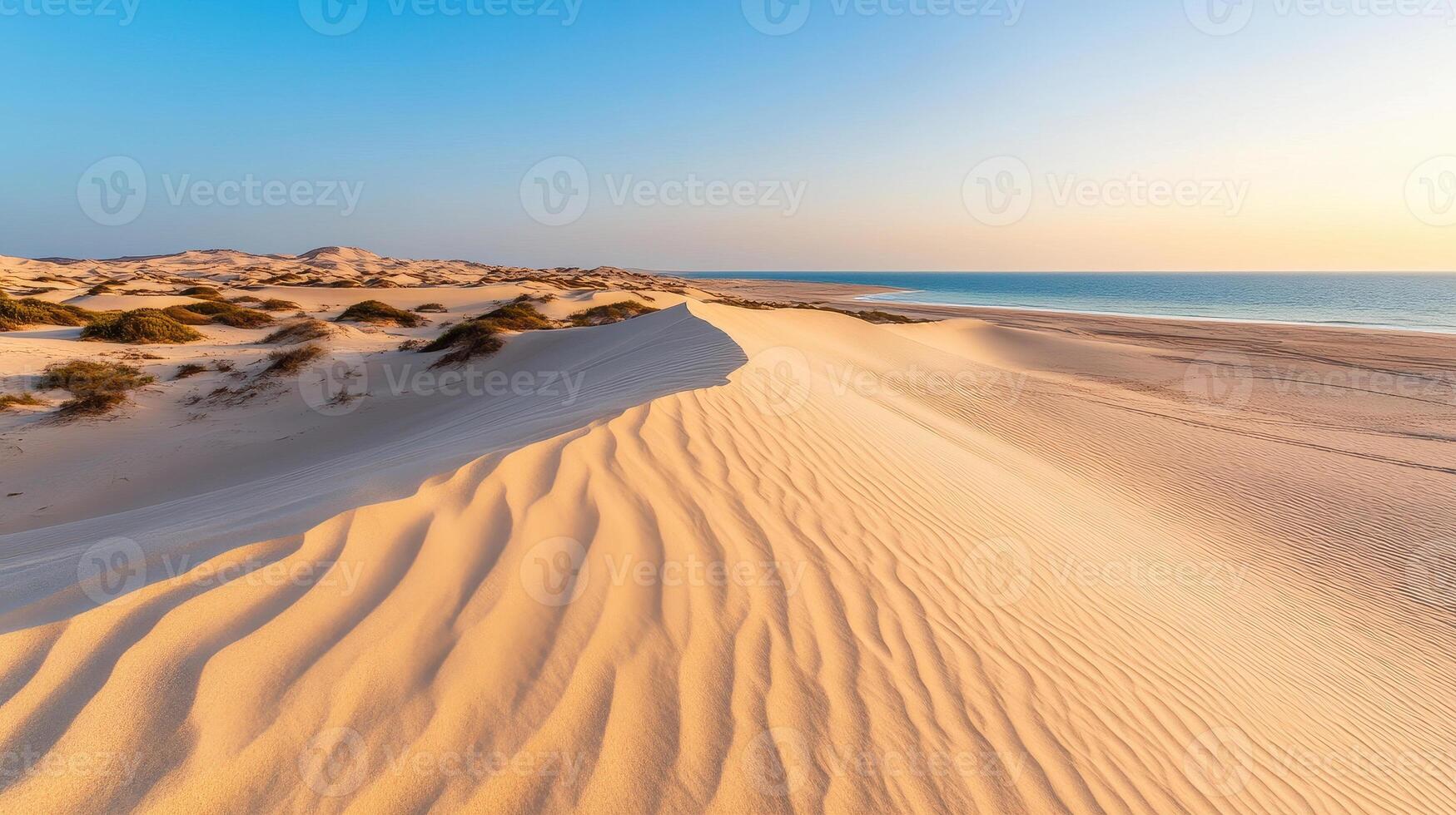 Wind blown sand creates soft flowing lines on serene beach landscape, showcasing beauty of nature patterns and tranquil meeting of land and sea photo
