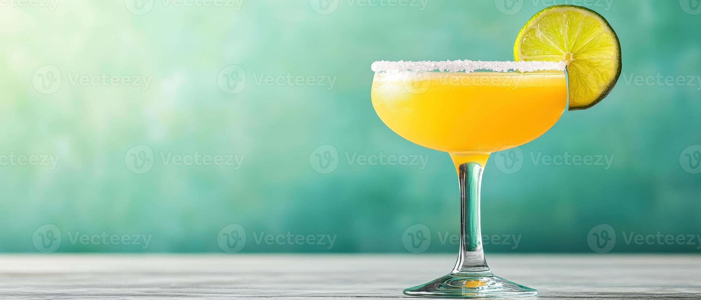 vibrant cocktail glass filled with refreshing orange drink, garnished with lime slice and salted rim, perfect for summer gatherings photo