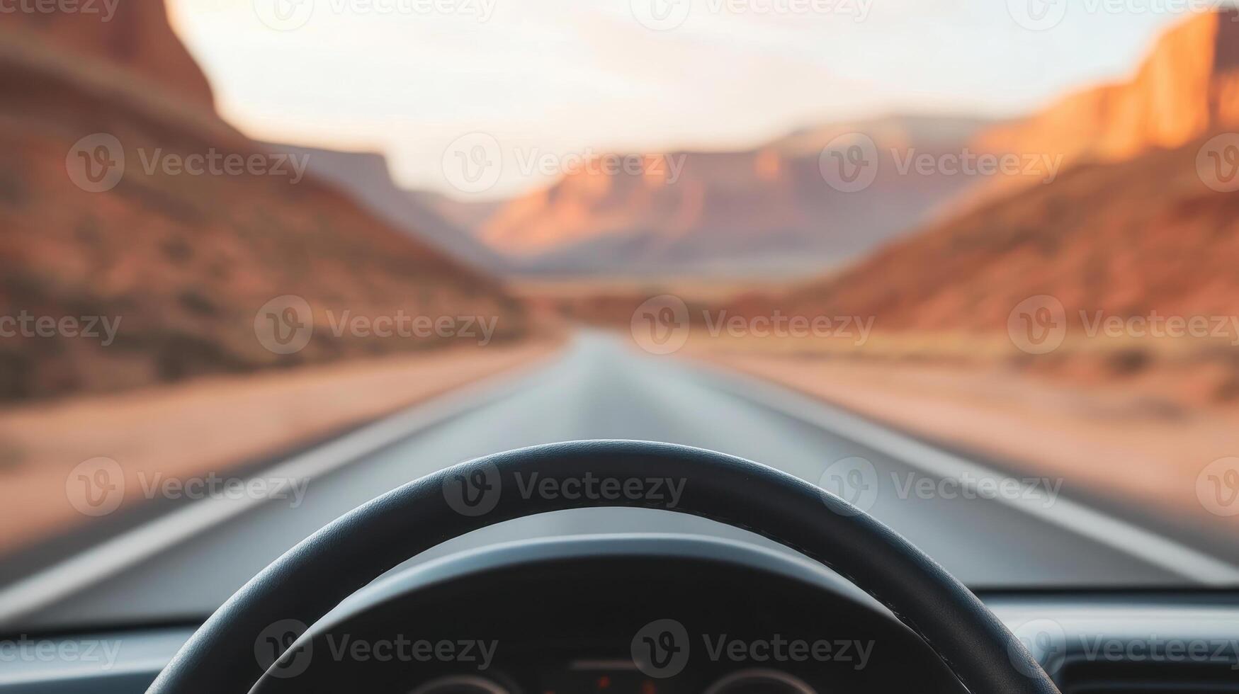 scenic view of road stretching through desert landscape, seen from inside car. warm colors of mountains create serene atmosphere, perfect for road trip adventure photo