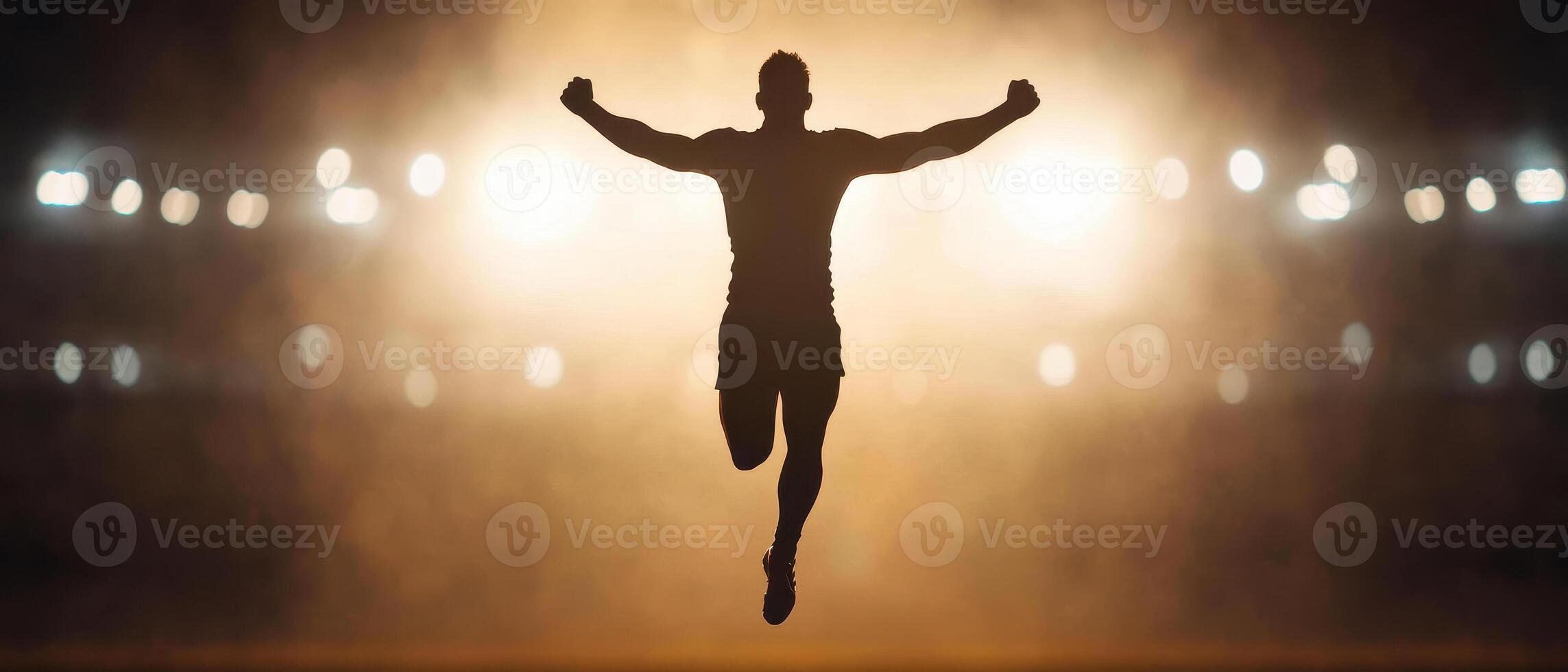 Silhouette of victorious athlete celebrating under stadium lights, exuding triumph and energy photo