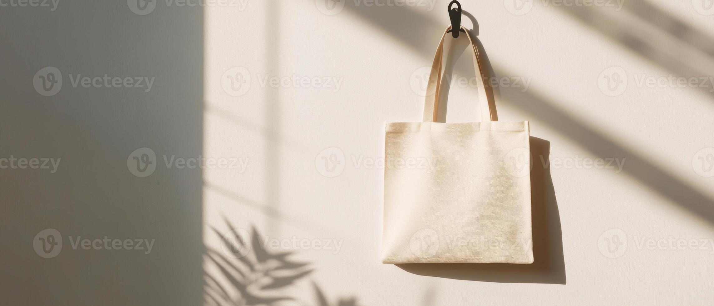 minimalist reusable tote bag hanging from hook, showcasing natural fabric texture and soft shadows, creating serene and eco conscious atmosphere. Perfect for advertising with ample copy space photo