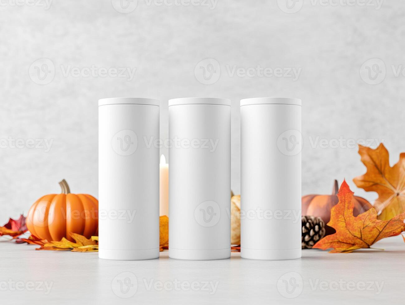 White tumblers on table with autumn leaves, pumpkins, and candles create cozy seasonal atmosphere. Perfect for fall themed decor or beverage presentations photo