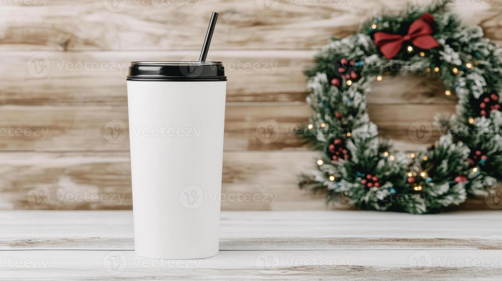 blank white tumbler mockup stands against festive wreath backdrop, perfect for holiday promotions. Ideal for showcasing designs or branding photo
