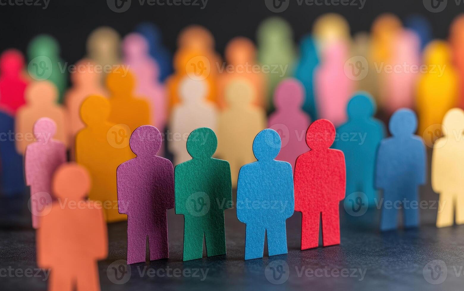 Colorful paper cutouts of people in various shades create vibrant scene, symbolizing diversity and community. arrangement highlights unity and togetherness photo