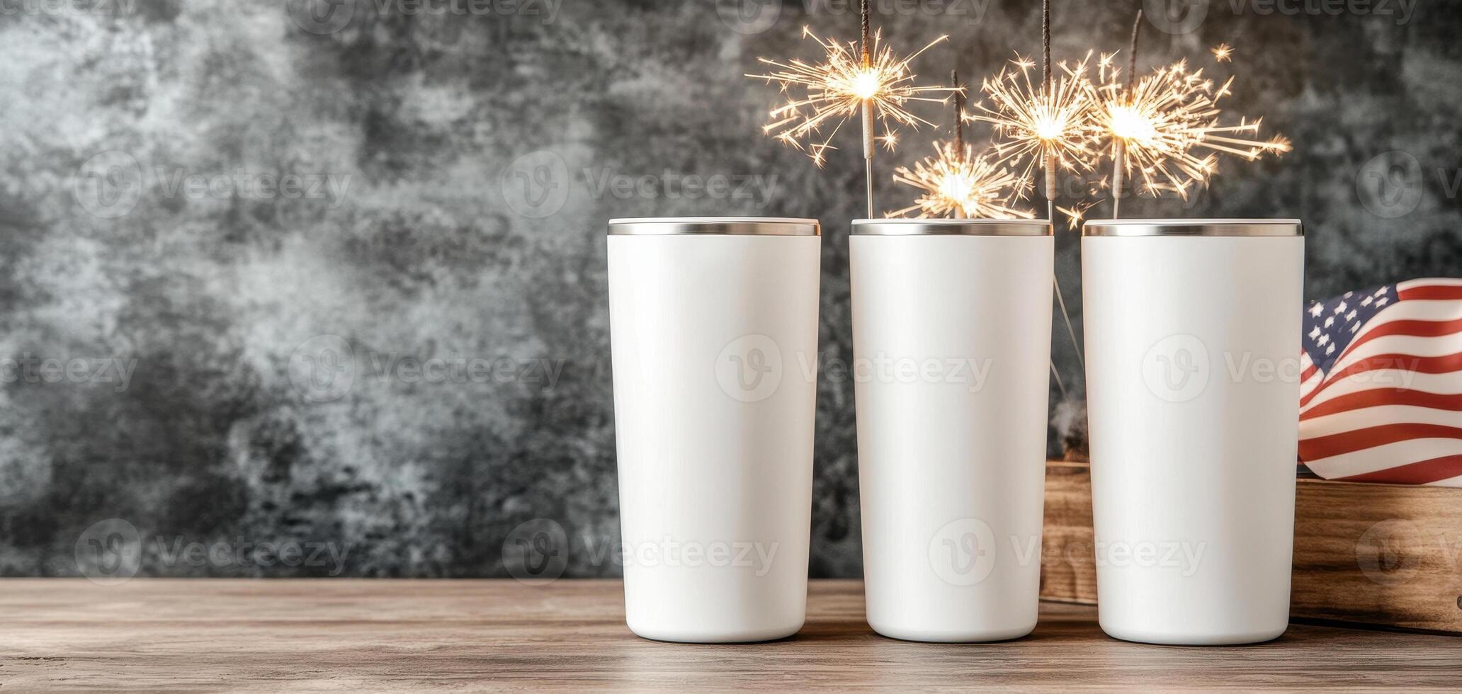 White tumblers with sparklers and American flag on wooden table photo