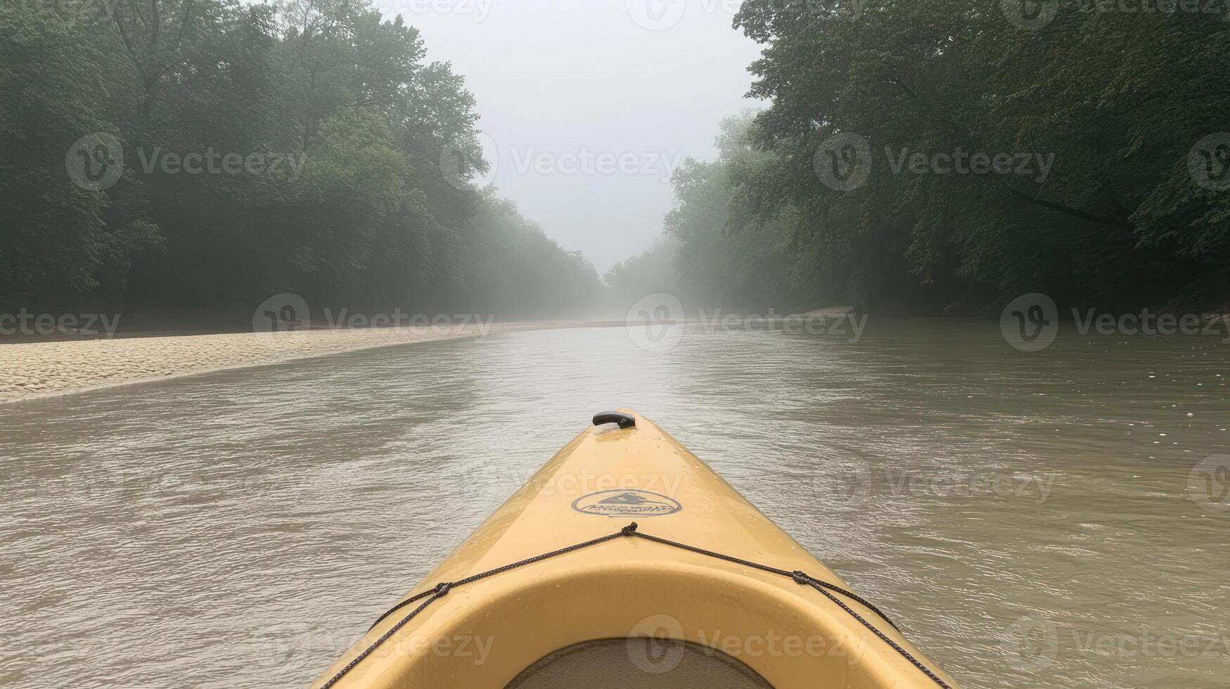 Paddling gently down a serene river, enveloped in fog, with trees lining the banks photo