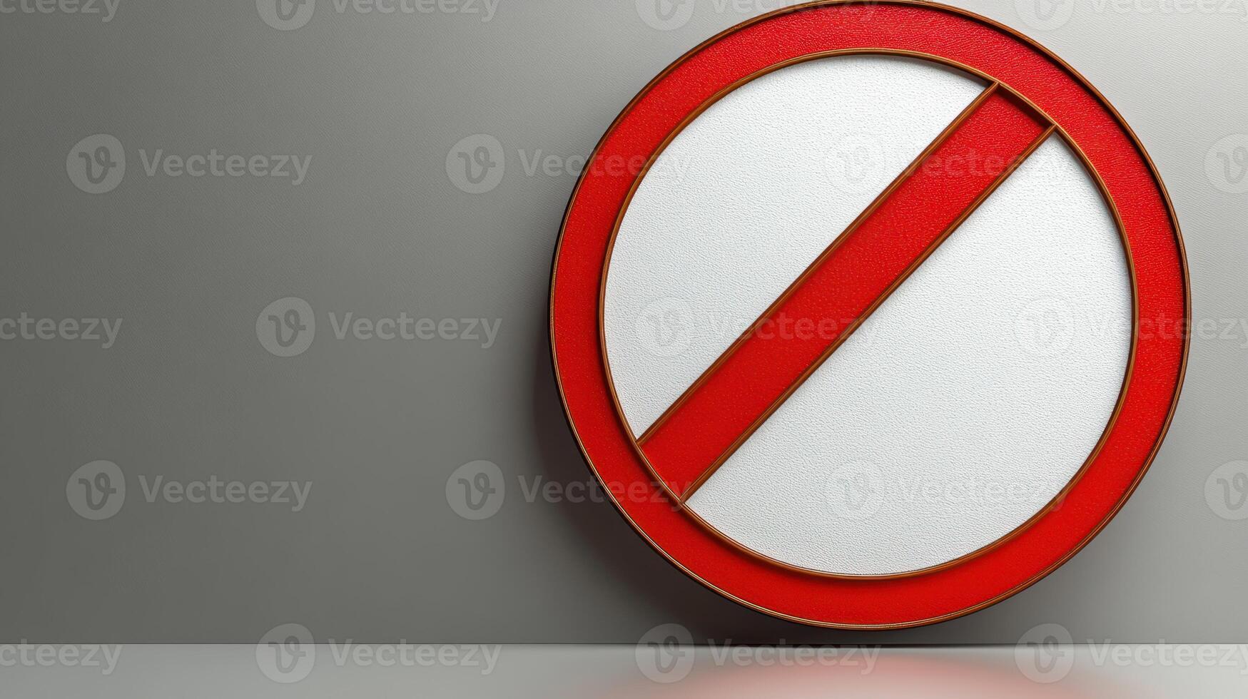 A vibrant no entry sign is prominently placed against a neutral gray wall, symbolizing restrictions photo