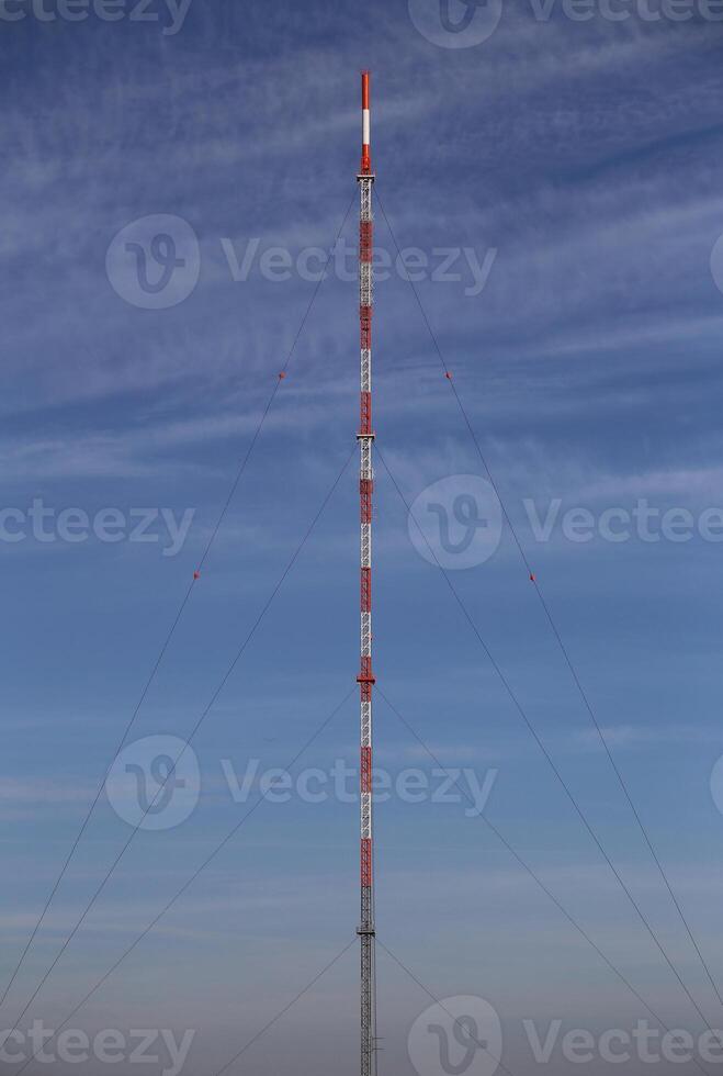 Symmetric view of red and white radio tower photo