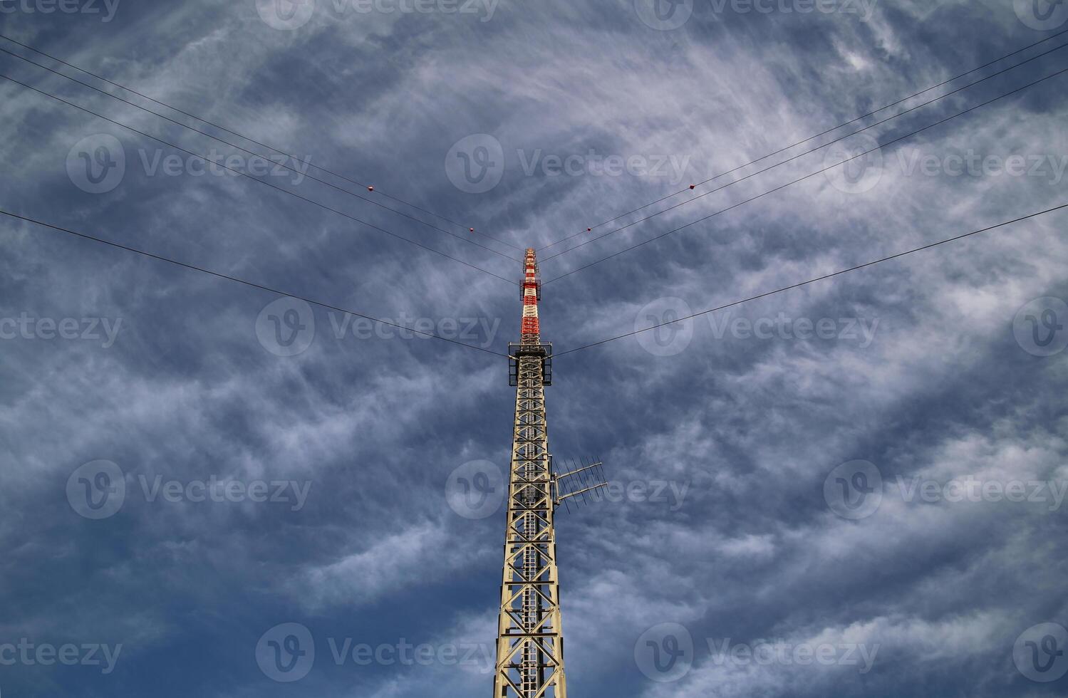 Red and white radio tower in an unusual angle. photo