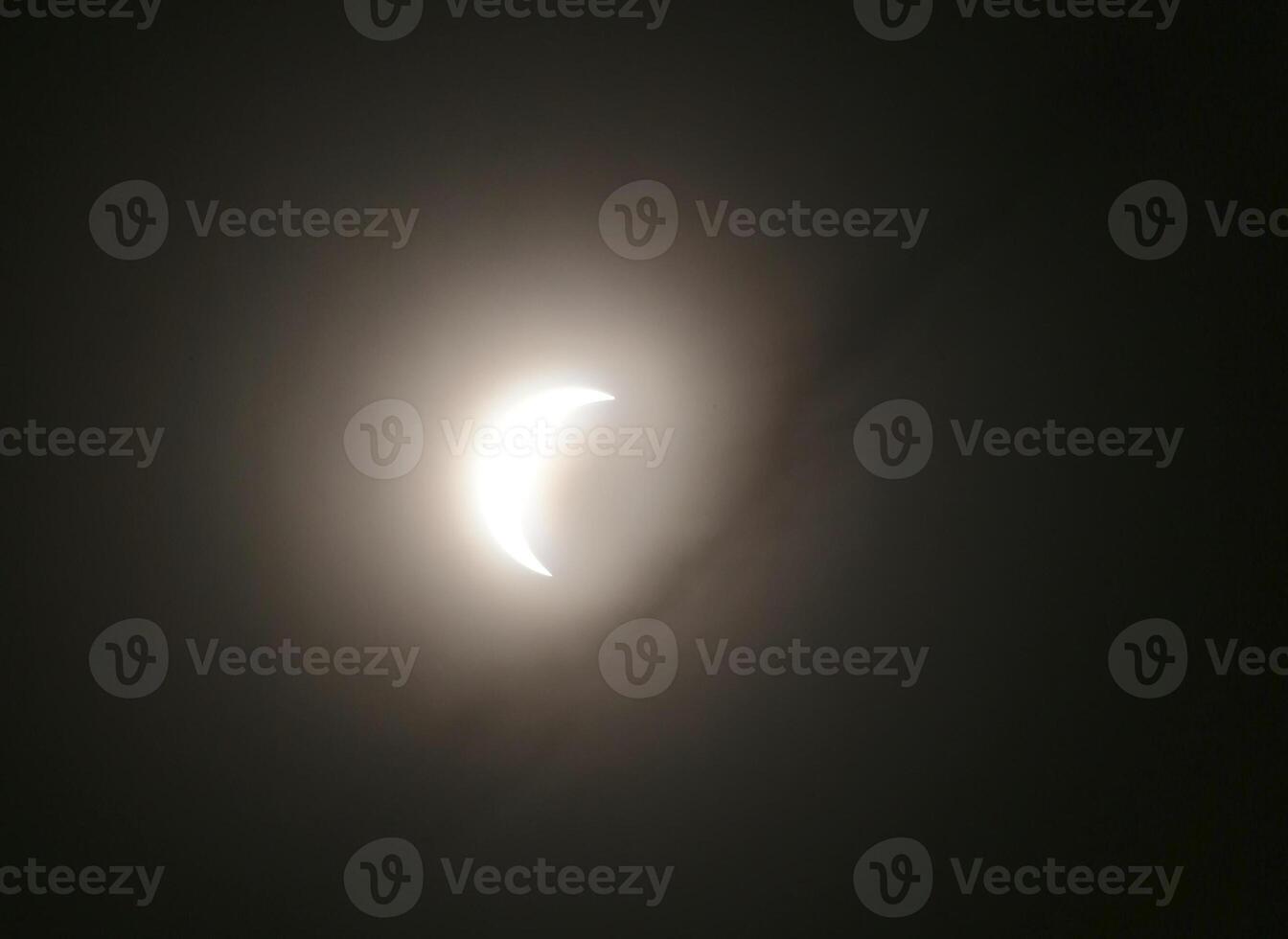 HDR shot of solar eclipse on March 20, 2015 in Germany, with cloud silhouettes. photo