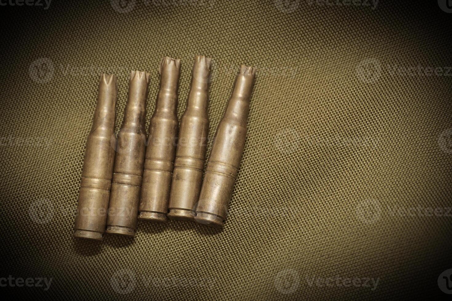 Bullet casings on textile with sepia effect and vignetting. photo